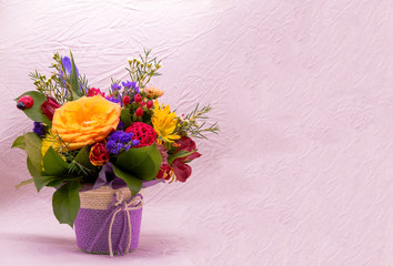 bouquet of flowers in a vase on wooden background