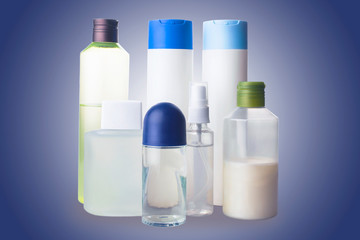 Flat lay composition with bottles of perfume on color background