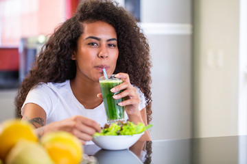 Young african woman enjoy healthy vegetarian smoothie for weight loss and detox.