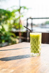 iced matcha green tea glass on the table
