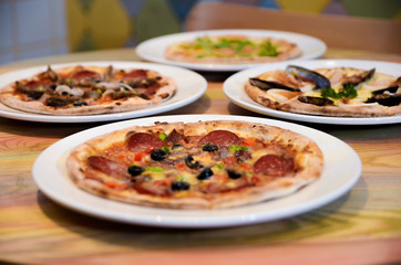 Slice of hot pizza cheese lunch or dinner crust seafood meat topping sauce with bell pepper vegetables delicious tasty fast food italian traditional on wooden board table classic with delivery hand 