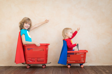 Happy children driving toy car at home