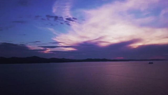 Aerial pan across the beautiful coastline of Zadar, Croatia with a dramatic sunset over the ocean
