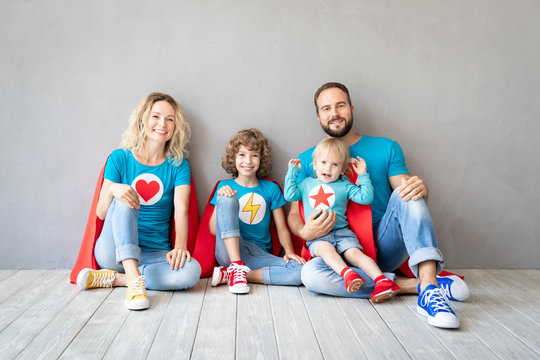 Family of superheroes playing at home