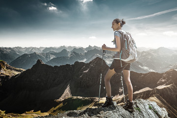 Young athletic woman hiker on mountain summit