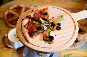 Slice of hot pizza cheese lunch or dinner crust seafood meat topping sauce with bell pepper vegetables delicious tasty fast food italian traditional on wooden board table classic with delivery hand 