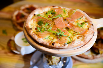 Slice of hot pizza cheese lunch or dinner crust seafood meat topping sauce with bell pepper vegetables delicious tasty fast food italian traditional on wooden board table classic with delivery hand 