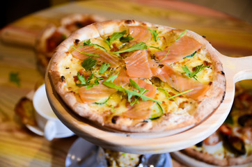 Slice of hot pizza cheese lunch or dinner crust seafood meat topping sauce with bell pepper vegetables delicious tasty fast food italian traditional on wooden board table classic with delivery hand 