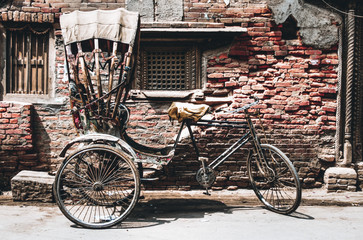 Old rickshaw bicycle taxi parked in a street