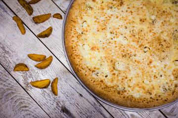 A whole big pizza close-up on a gray background. Colorful pizza topping closeup