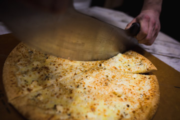 Appetizing large pizza cut into pieces, lying on the Board with numbers indicating its diameter...