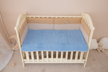 Fototapeta na wymiar White children's beds, blue mattresses