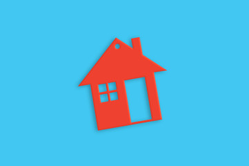 Fototapeta na wymiar One red plastic house with window and door on blue table. Top view. Household concept