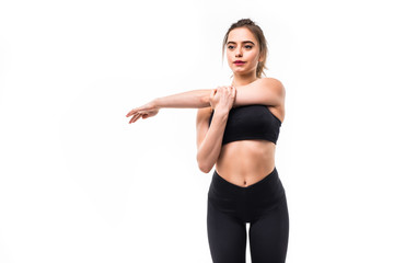 Portrait of a smiling fitness woman stretching her hands over white background