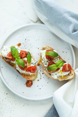 Breakfast: toasts with cream cheese and tomatoes