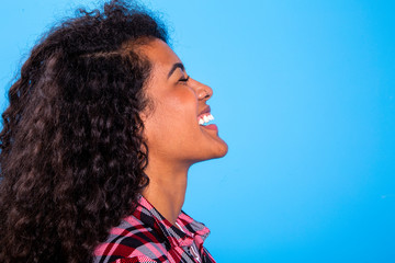 side view of pretty african woman beauty on blue background - Imagem