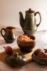 sauerkraut with boiled potatoes on a cutting board and a light background
