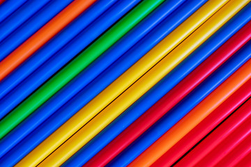 Colorful plastic tubes straws diagonal background 