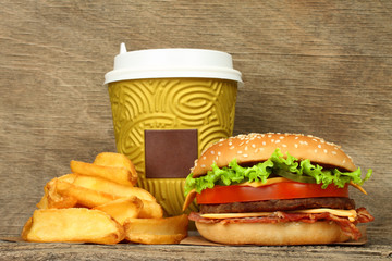 Big hamburger with french fries and paper coffee cup