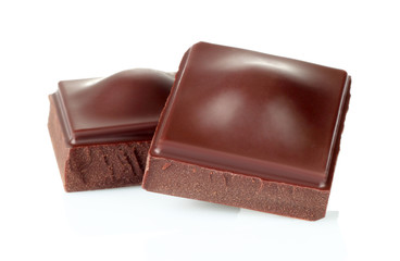 Dark chocolate pieces isolated on white background