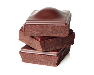 Dark chocolate pieces isolated on white background