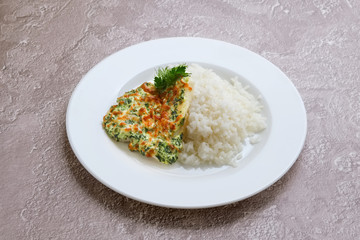 Fried hake fillet with spinach, cheese and rice