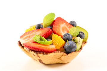 mixed fruit salad in biscuit bowl on white background