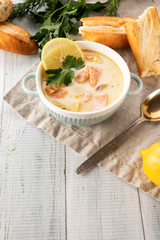Finnish creamy soup with salmon, potatoes, onions, and carrots