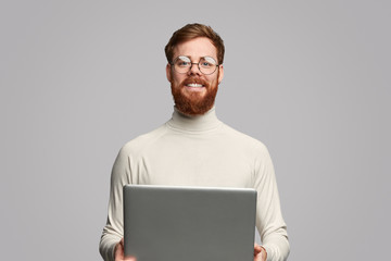 Cheerful programmer with laptop