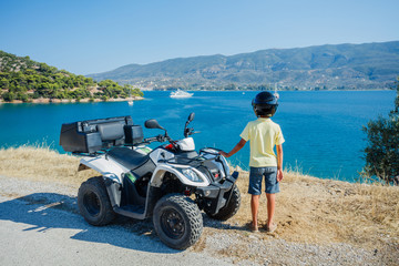 Little boy riding quad bike. Cute child on quadricycle. Motor cross sports on Greece island. Kids summer vacation activity. © Max Topchii