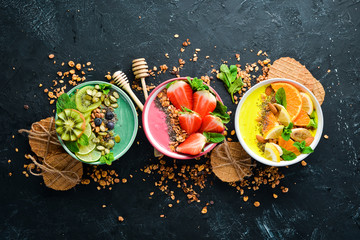 A great set of colored fruit smoothies with yogurt, fresh fruit and berries. A healthy breakfast....