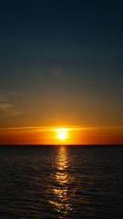 Naklejka premium Sunset or dawn at sea. Black Sea shore. Mobile Screensaver, Vertical Layout, Nature Wallpaper. Beautiful Colors, Marine Theme Concept