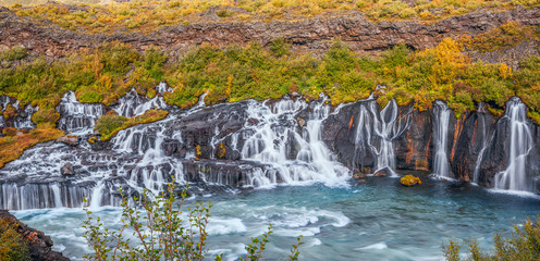 Panoramic view of the Hraunfossar waterfall in early autumn.Iceland