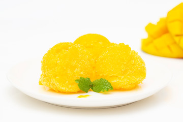 Mango sorbet, summer dessert decorated with mint leaves. Closeup of a bowl of mango sorbet.  