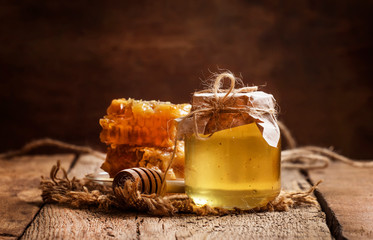 Honey jar and honeycomb, vintage wooden kitchen table background, copy space, selective focus - Powered by Adobe