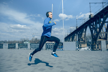 Man running on city background at morning. Healthy lifestyle concept.