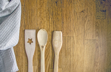 Kitchen utensils on wooden background. Various wooden kitchen utensils on table top view with copy space. Culinary Background