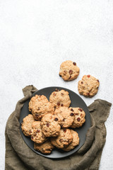 Oatmeal cookies with raisins and nuts on a light background copy space top view.