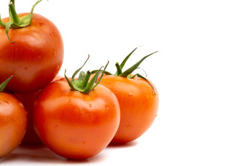 Tomato closeup on white background. Selective focus and crop fragment
