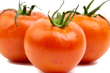 Tomato closeup on white background. Selective focus and crop fragment