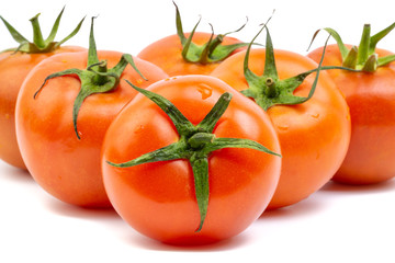 Tomato closeup on white background. Selective focus and crop fragment