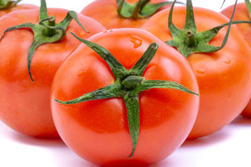 Tomato closeup on white background. Selective focus and crop fragment