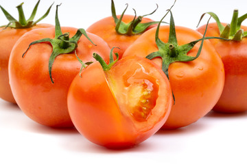 Tomato closeup on white background. Selective focus and crop fragment