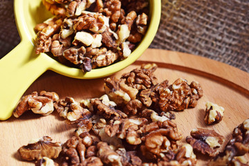 Useful walnuts on a burlap and wood background.