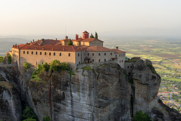 Fototapeta na wymiar Panoramic view in a spring sunny day of Agios Stefanos St Stefan Monastery Meteora monastery on the high cliff rock, Greece