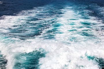 Texture, splashes and waves on the sea. Track on the water from the motor of the boat.