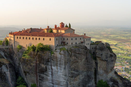 Panoramic view in a spring sunny day of Agios Stefanos St Stefan Monastery Meteora monastery on the high cliff rock, Greece © djevelekova