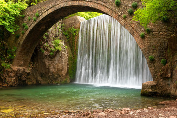 Stunning spring landscape.Paleokarya, old, stone, arched bridge, between two waterfalls. Trikala prefecture, Thessaly, Greece