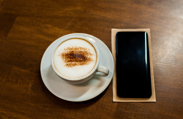 Fototapeta na wymiar cup of coffee on table in cafe