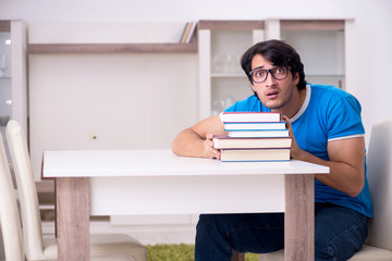 Young handsome student studying at home